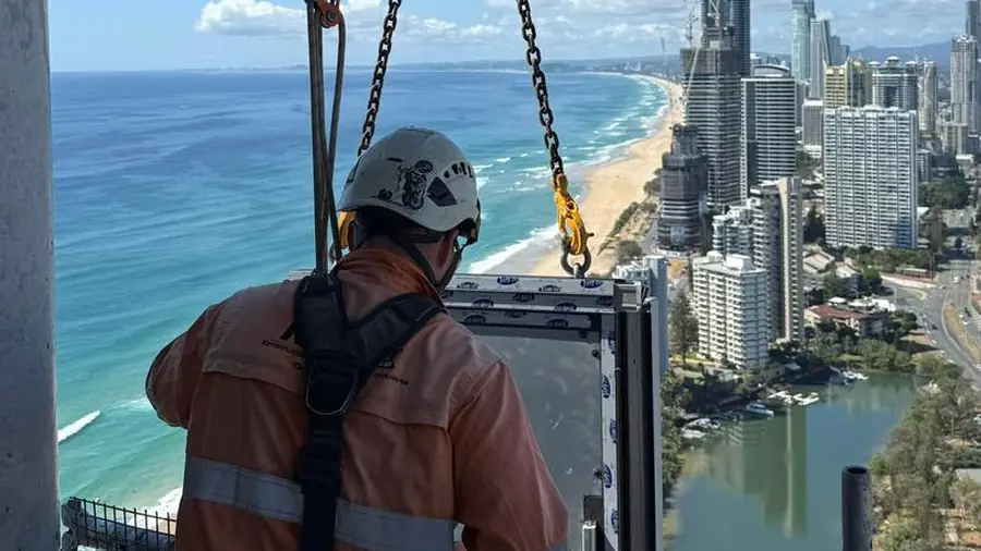 Rope access technician executing high-rise glazing work above the Gold Coast